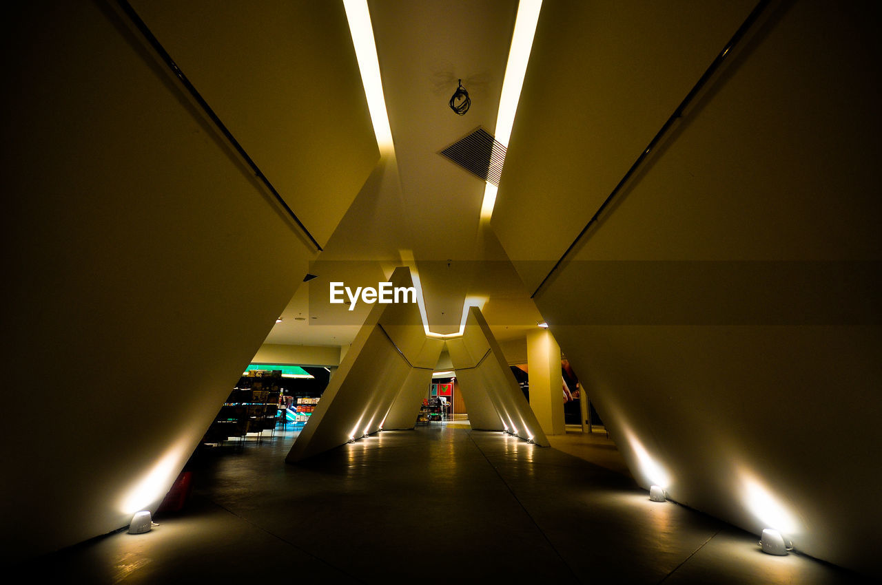 Low angle view of illuminated tunnel