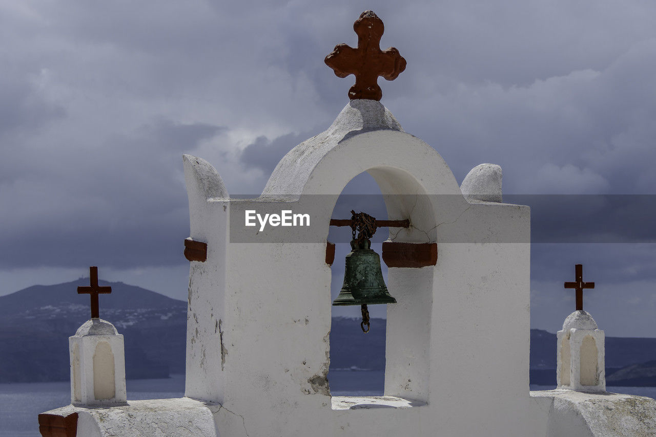 Santorini, greece, may 5, 2024. oia. traditional white bell tower of church with red crosses.