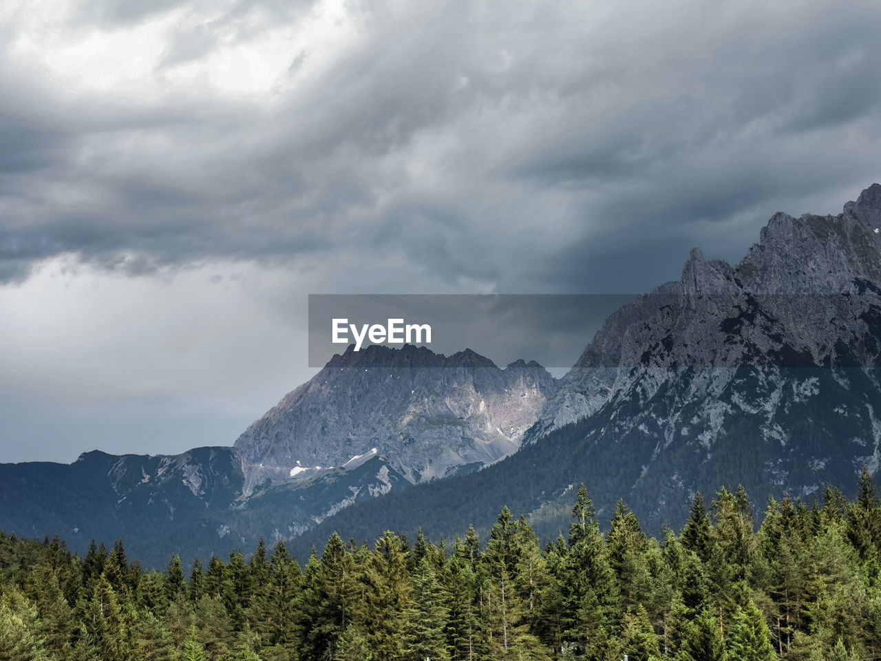 Scenic view of mountains against cloudy sky in mittenwald, bavarian alps 