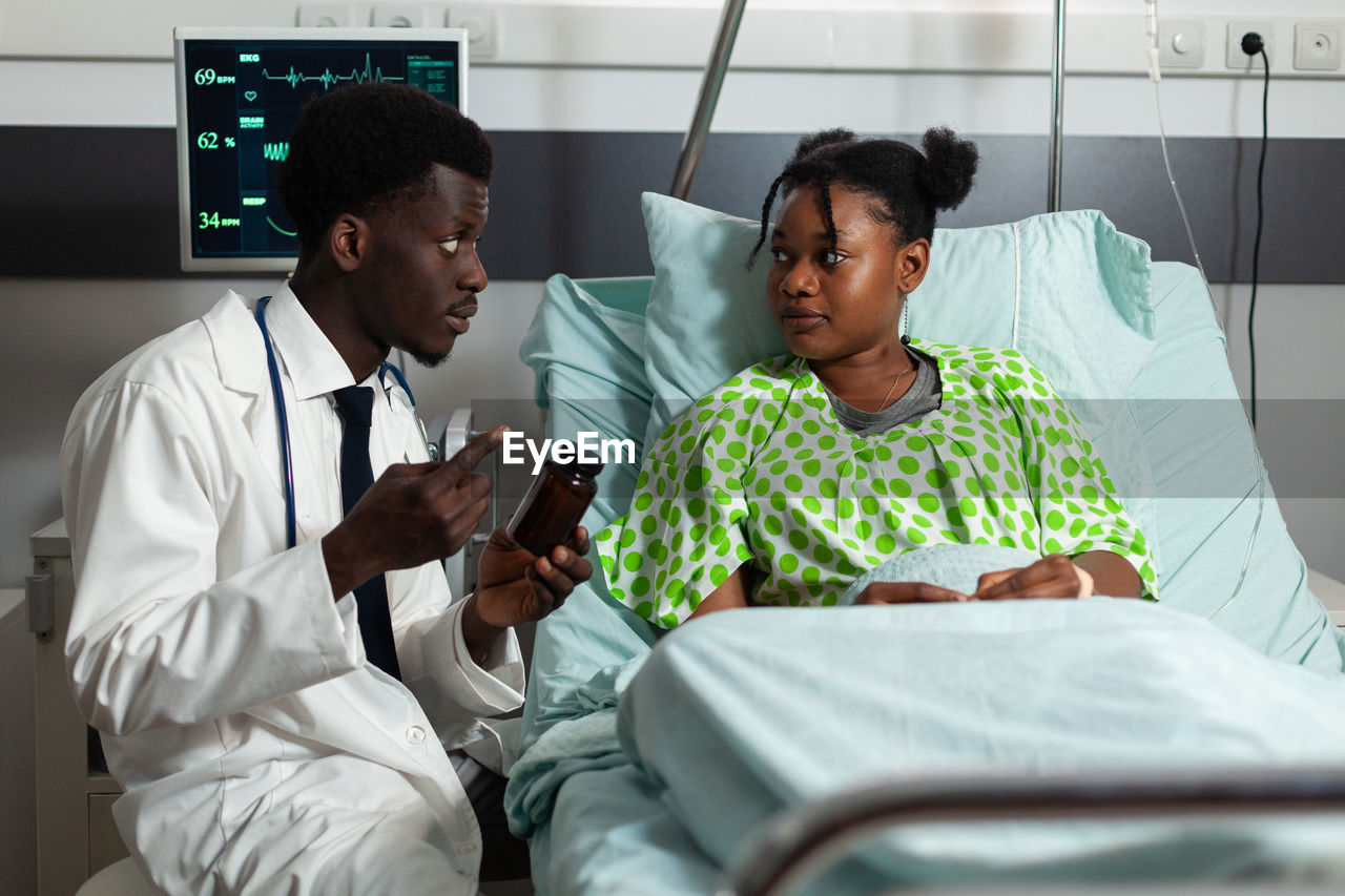 Portrait of doctor examining patient at clinic