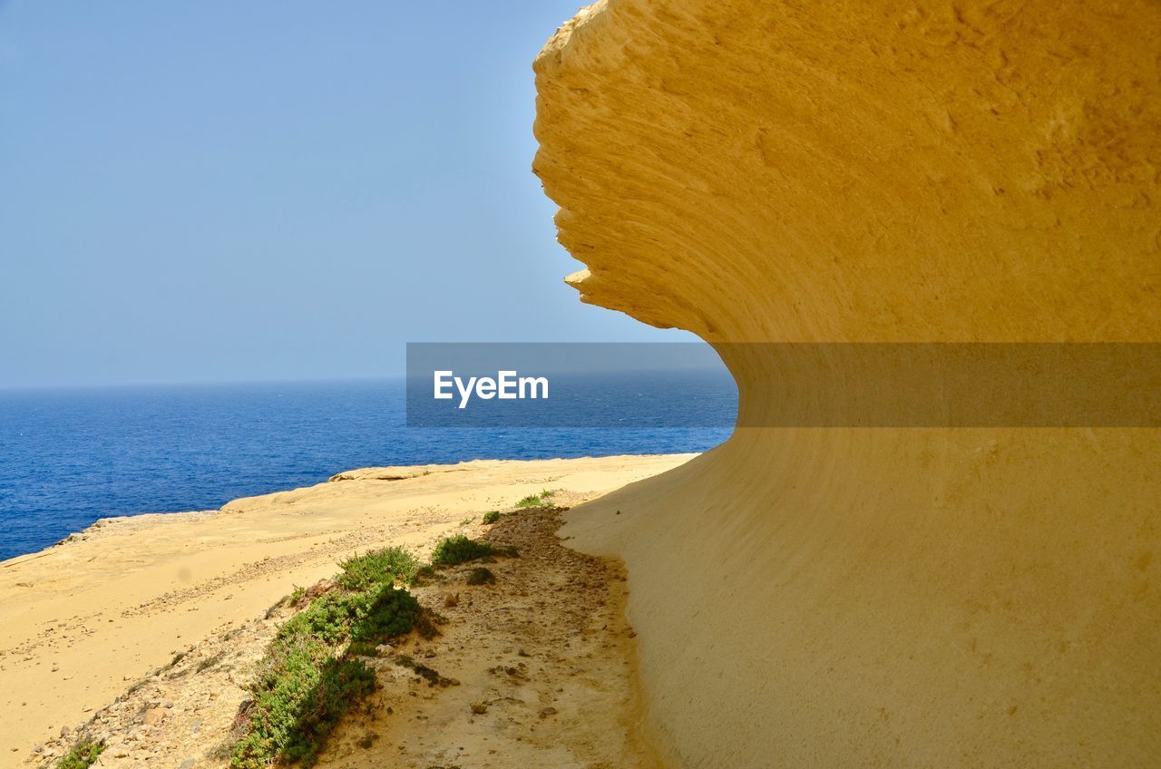 Scenic view of beach against clear sky