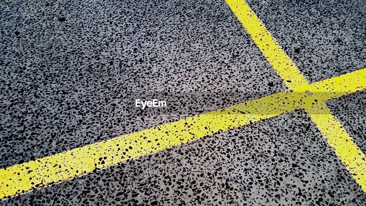 High angle view of yellow lines on parking lot