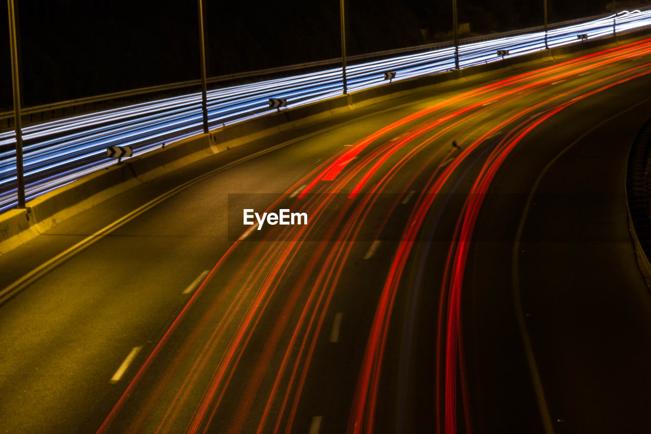 Light trails on bridge in city at night