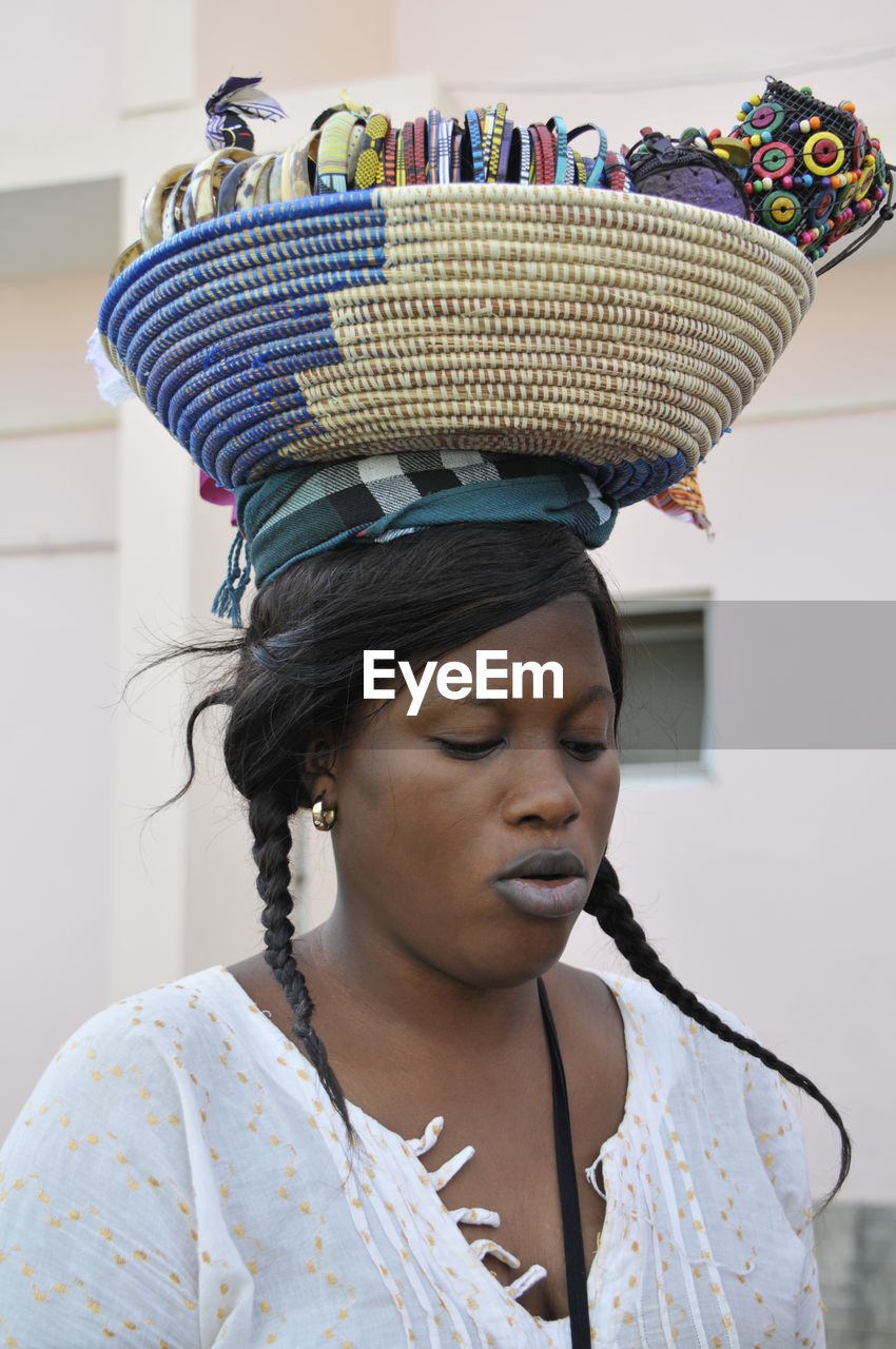 CLOSE-UP PORTRAIT OF WOMAN WEARING HAT