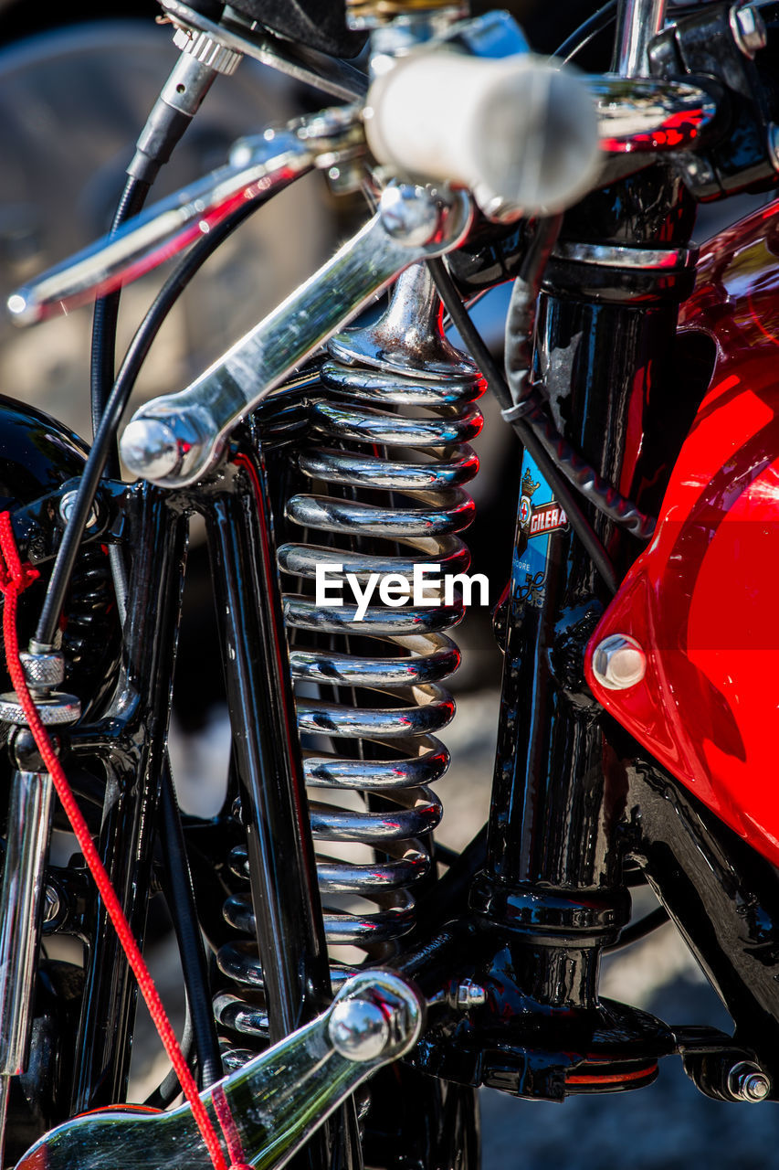 CLOSE-UP OF BICYCLE WHEEL WITH BICYCLES