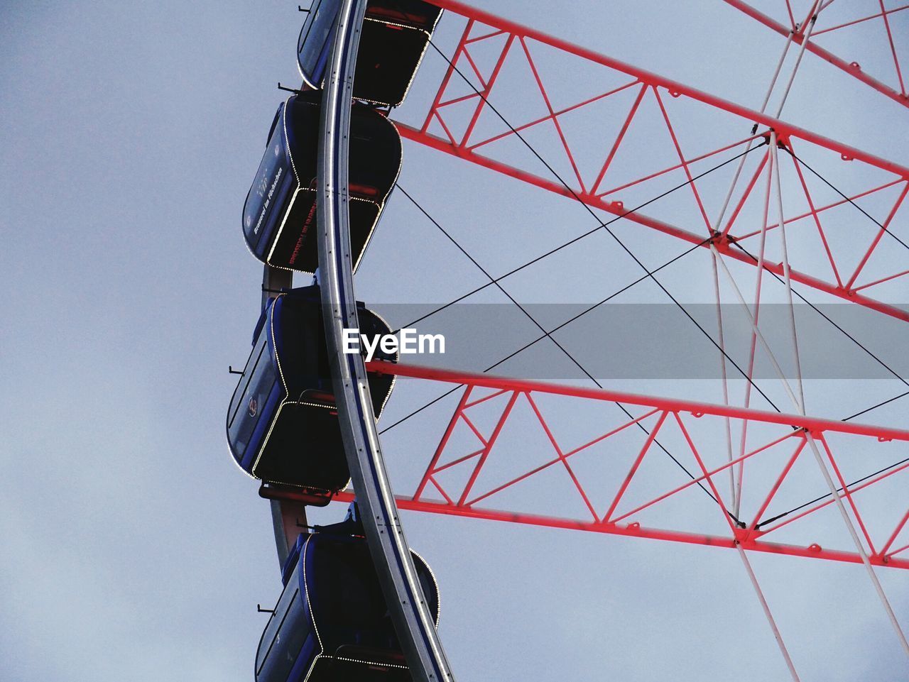 LOW ANGLE VIEW OF FERRIS WHEEL AGAINST THE SKY