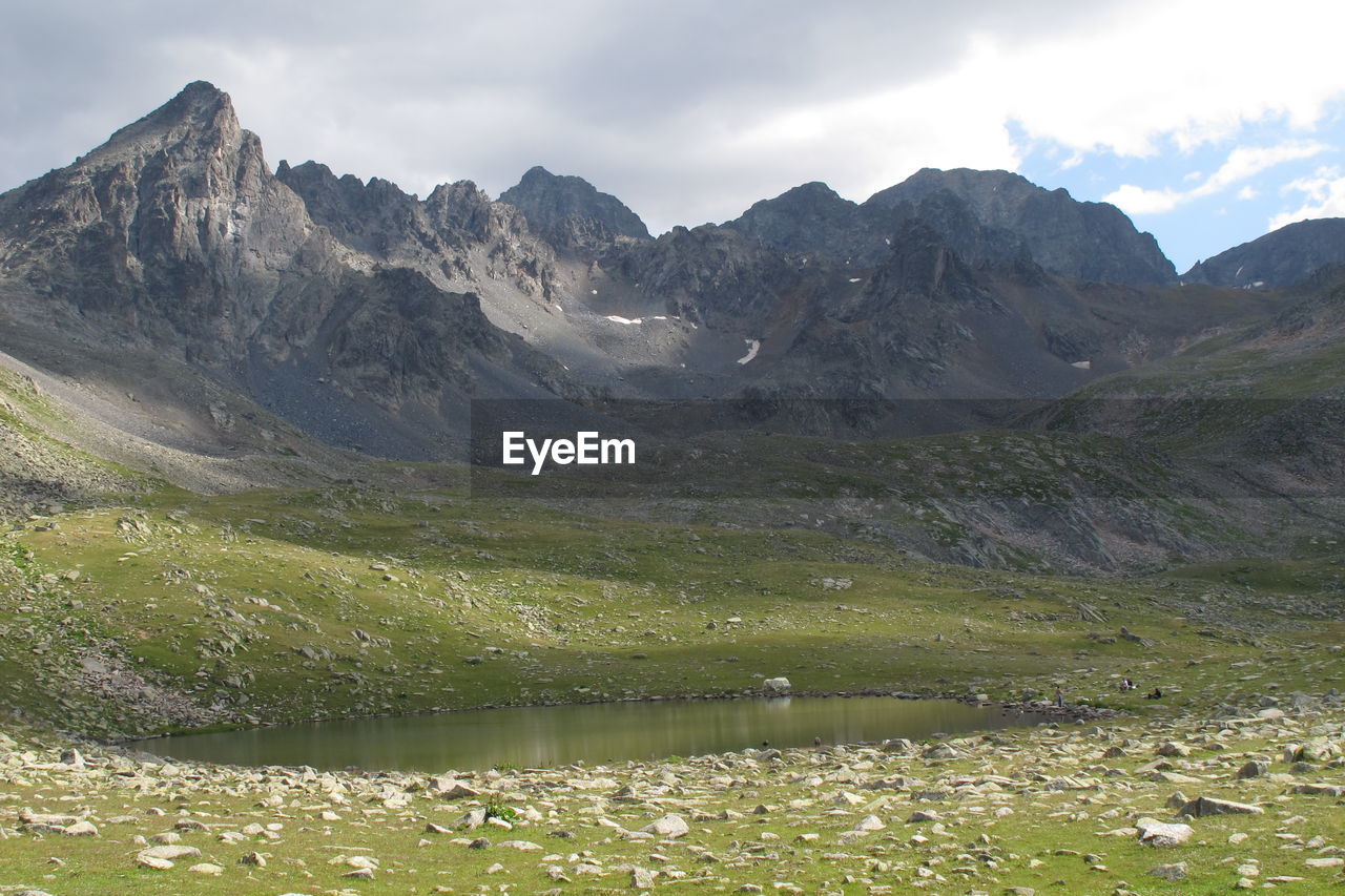 Scenic view of lake and mountains against sky