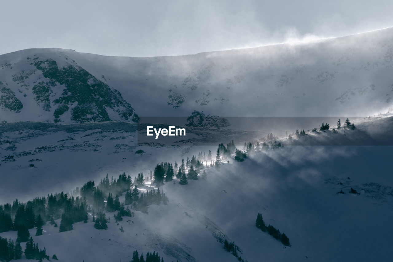 Scenic view of snow covered mountains against sky