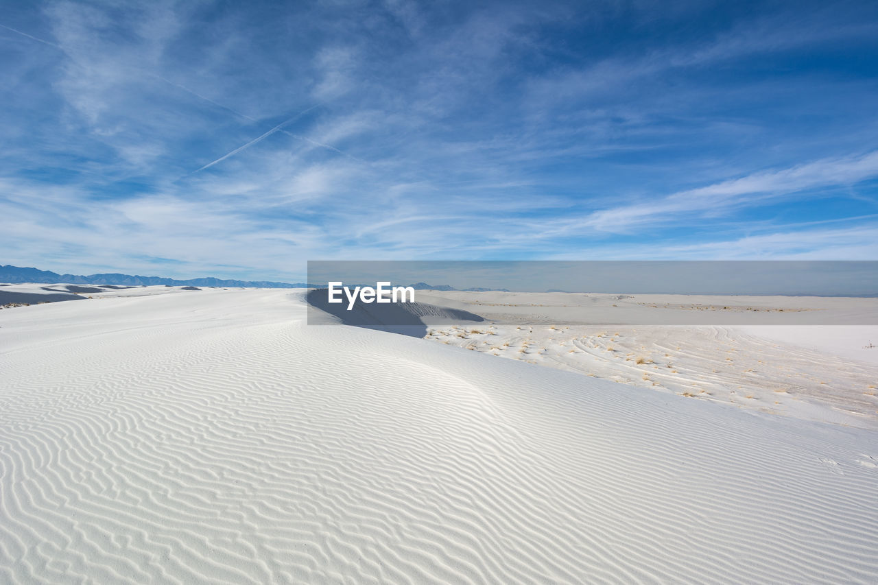 Scenic view of snow covered landscape against sky