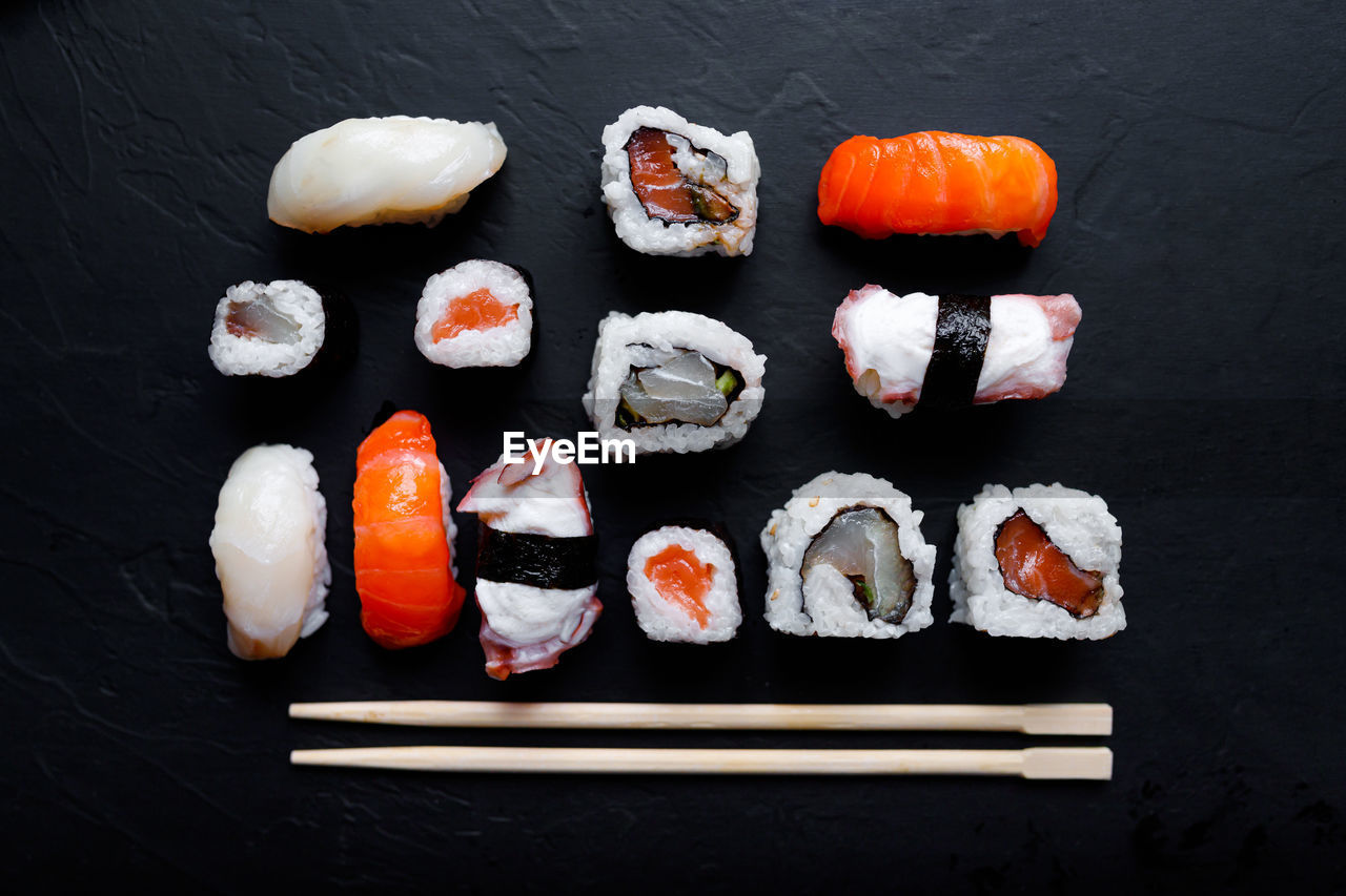 Directly above shot of sushi on black table