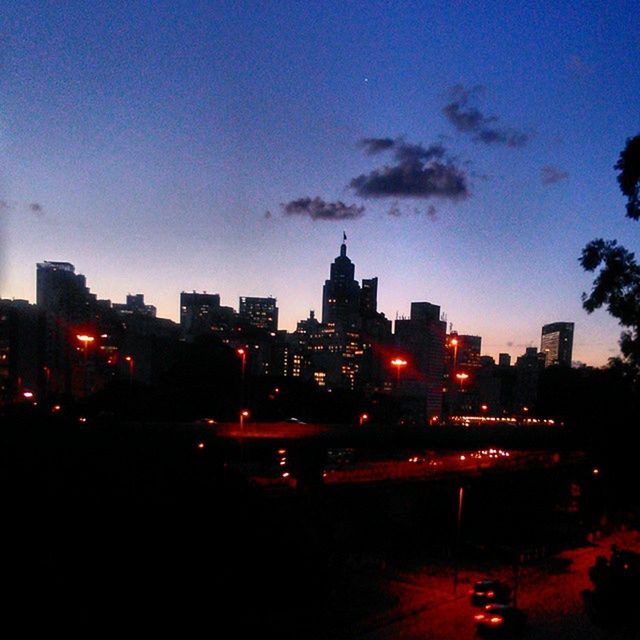 VIEW OF ILLUMINATED CITYSCAPE AT NIGHT