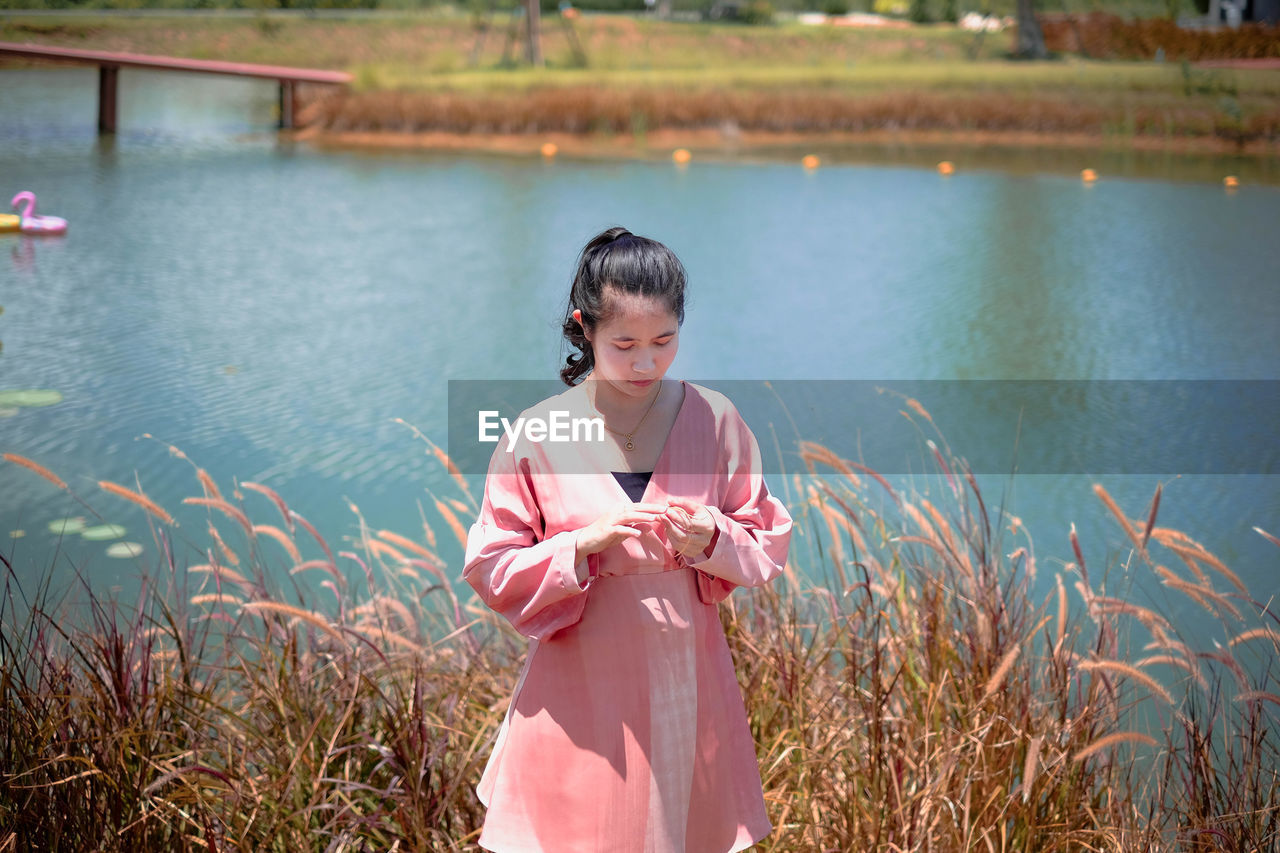 Full length of woman standing in water