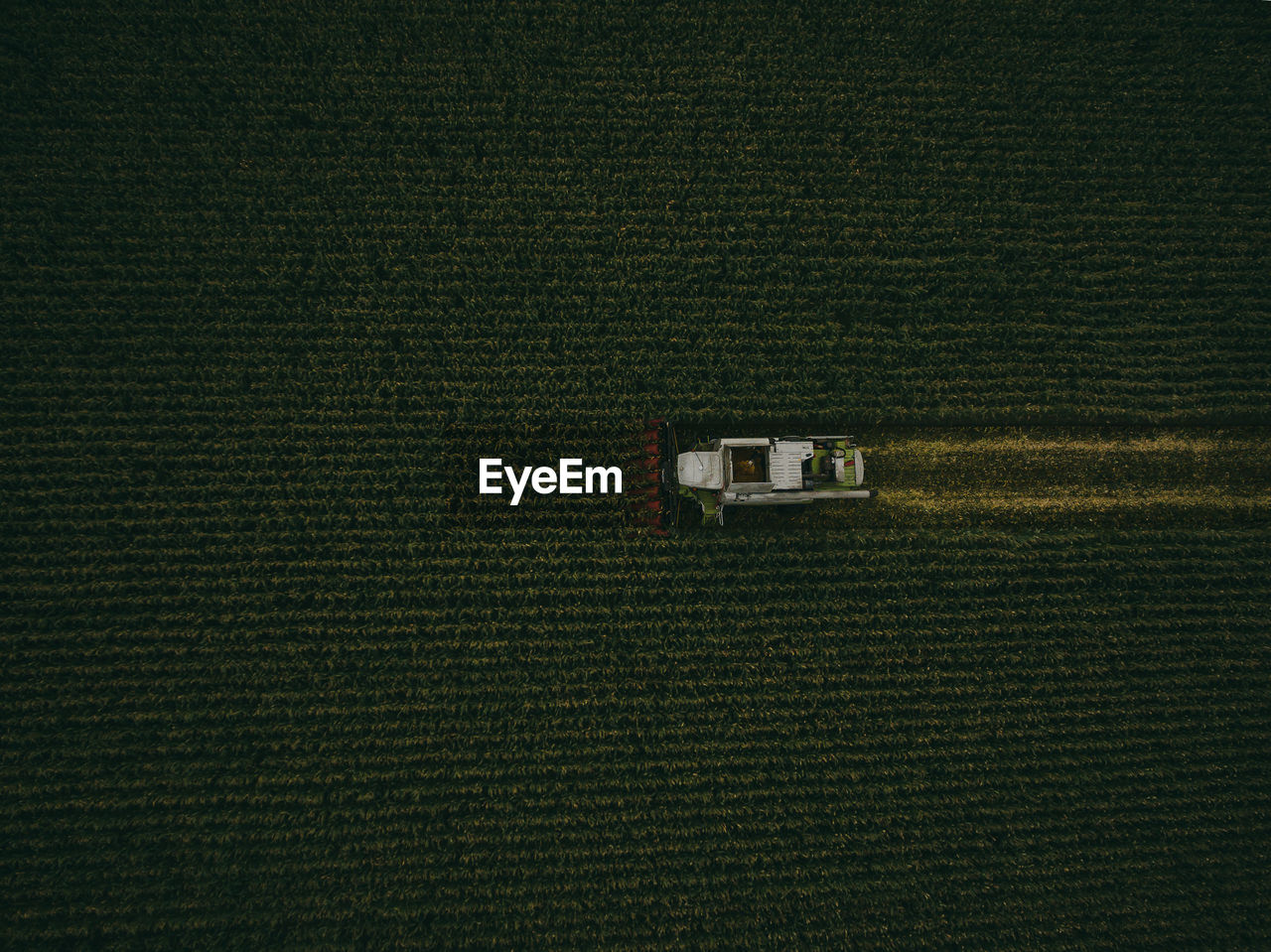 Aerial view of machinery working in agricultural field
