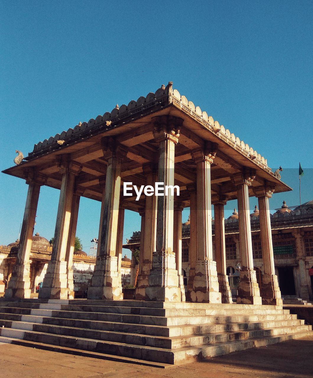 Low angle view of temple against clear blue sky