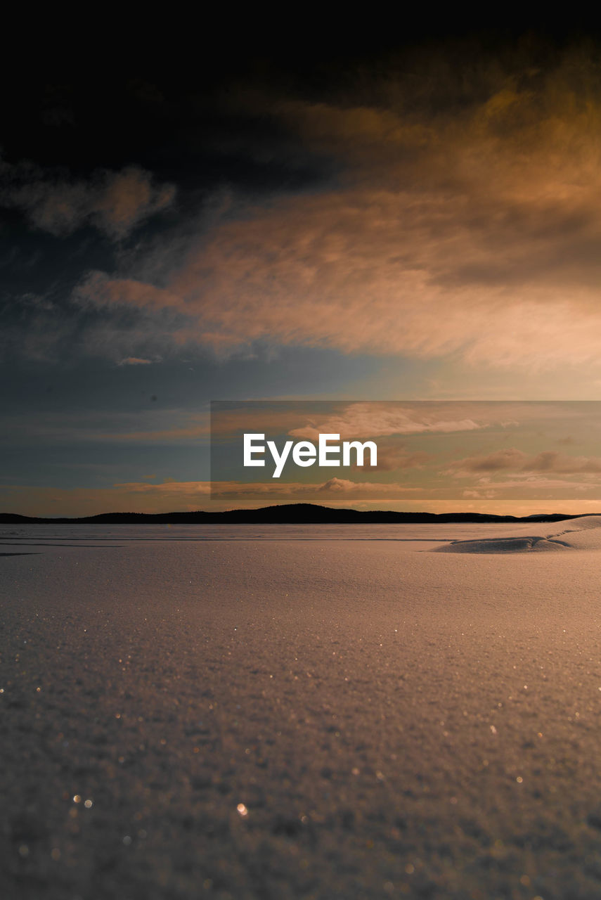 View of salt flat against sky during sunset