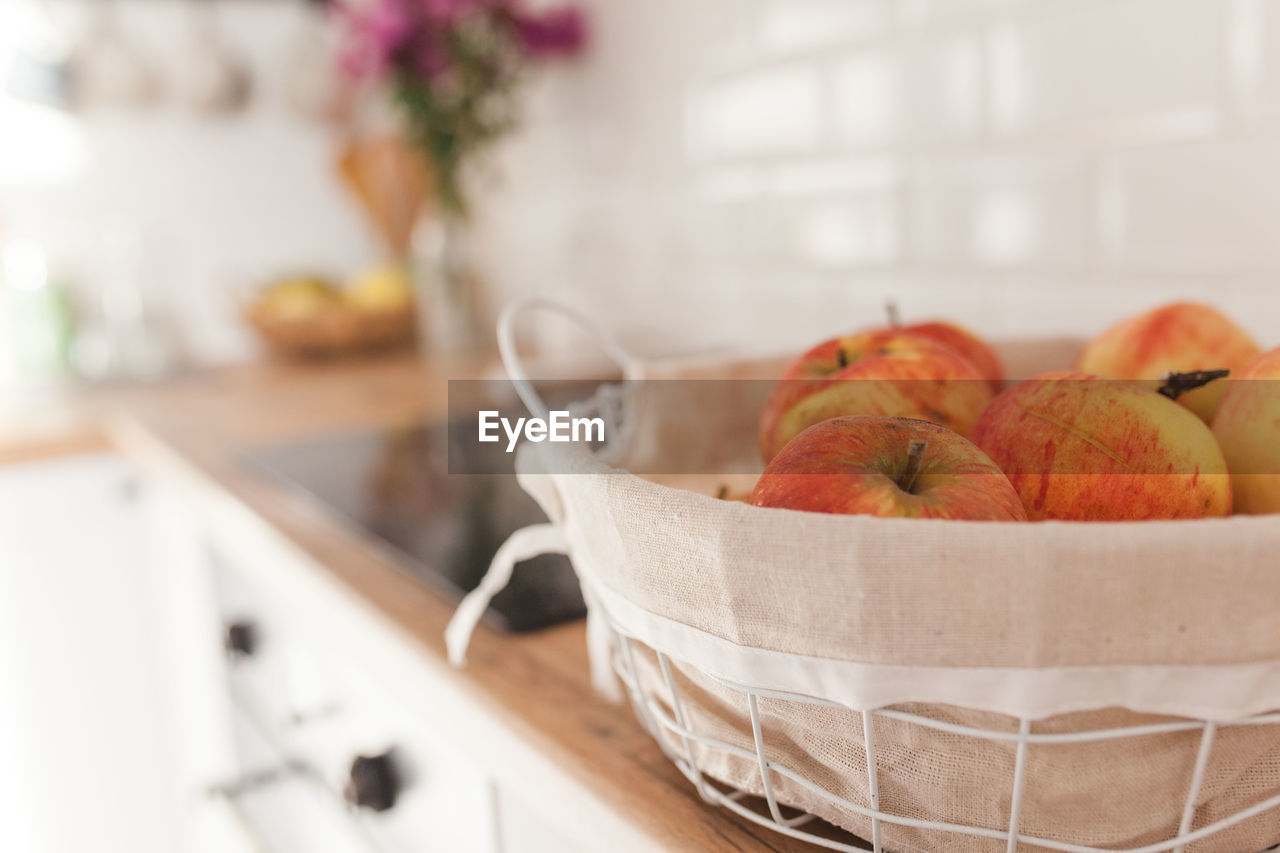 Apples in a basket on white scandinavian kitchen