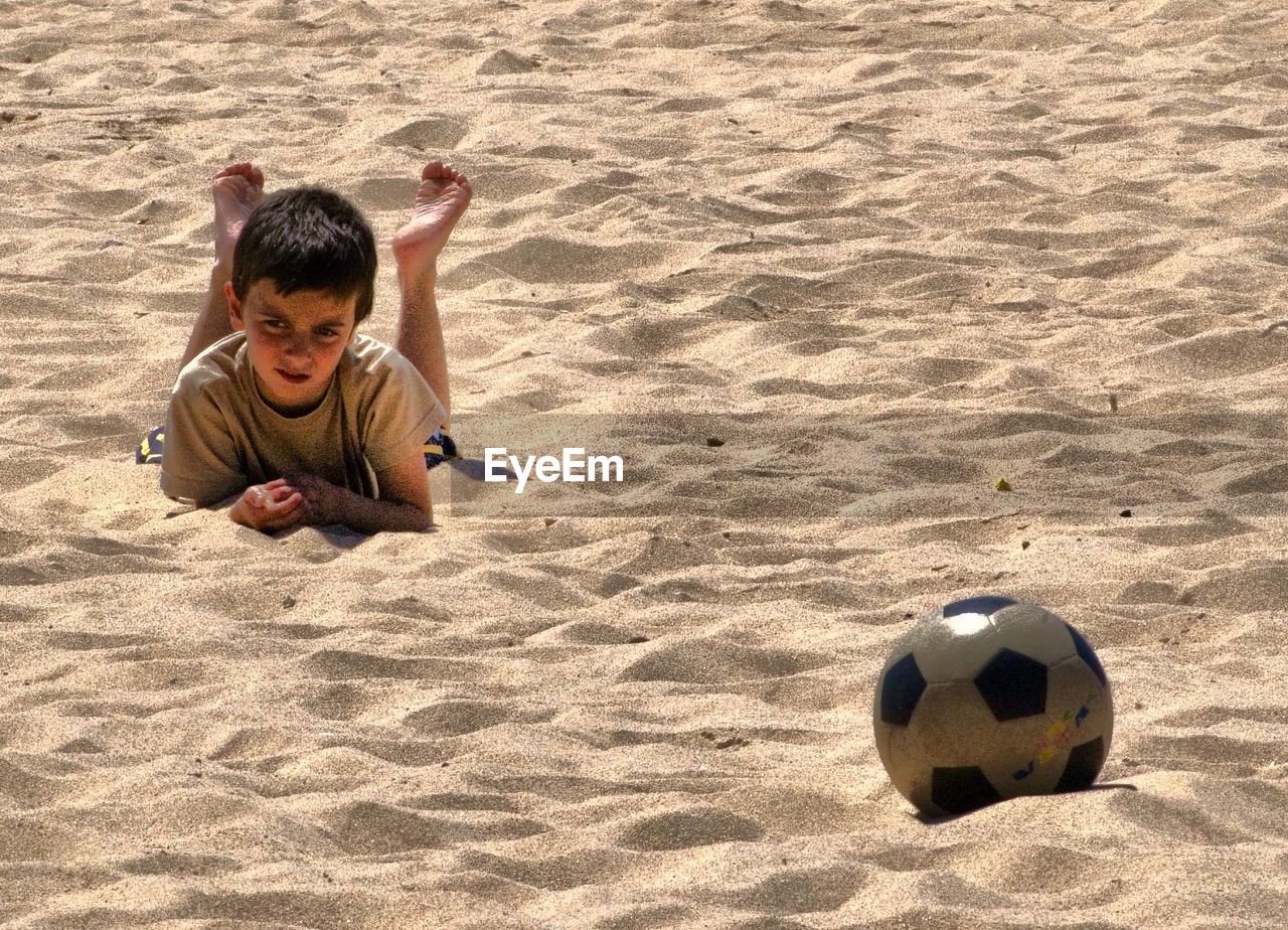 HIGH ANGLE VIEW OF CHILD PLAYING ON BEACH