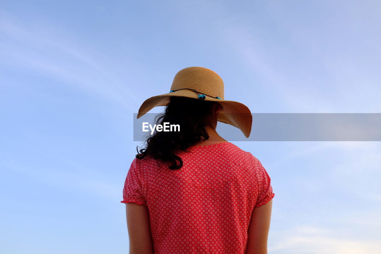 Rear view of woman wearing hat against sky