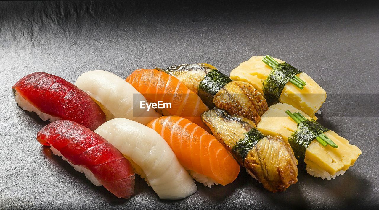High angle view of sashimi on wooden plate