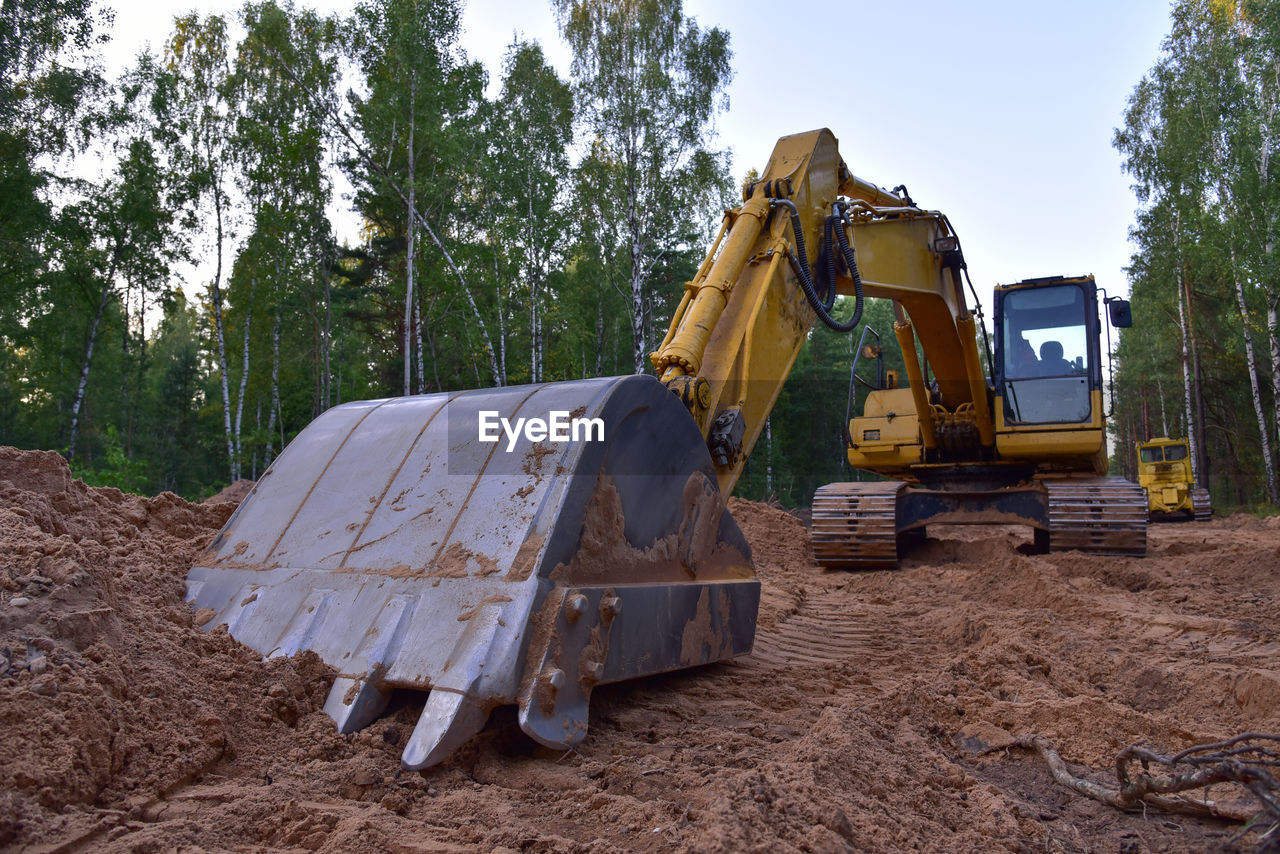Excavator clearing forest for new development and road work. backhoe for forestry work. 