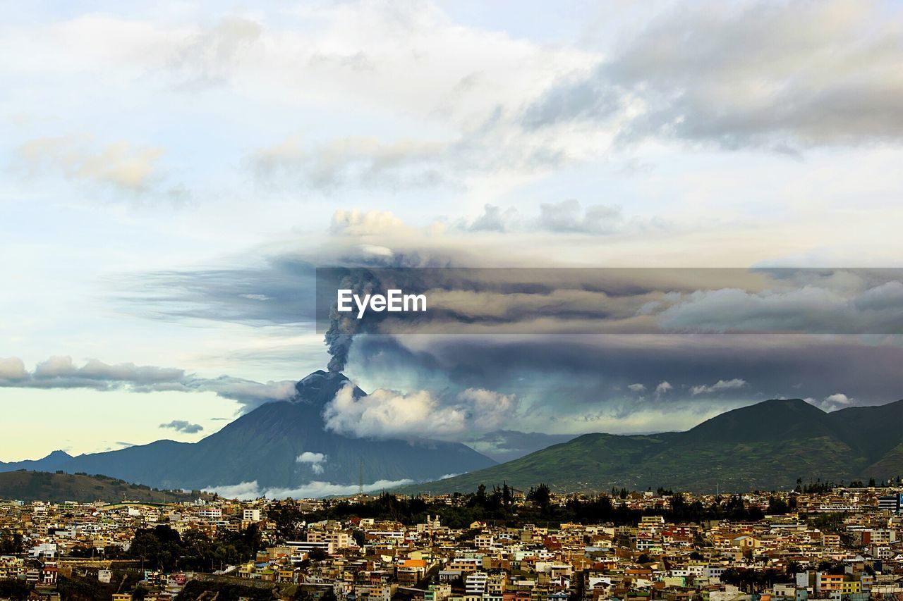 Aerial view of city against cloudy sky