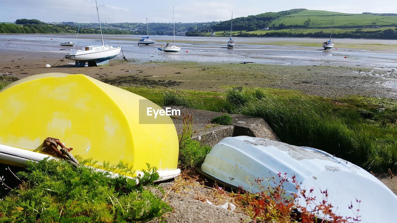 CLOSE-UP OF BOATS MOORED ON BEACH