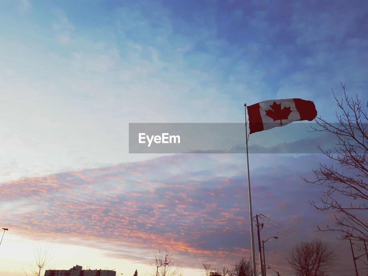 LOW ANGLE VIEW OF FLAGS AGAINST MOUNTAIN