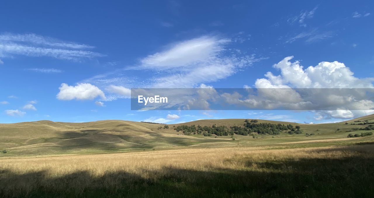 PANORAMIC VIEW OF LANDSCAPE AGAINST BLUE SKY