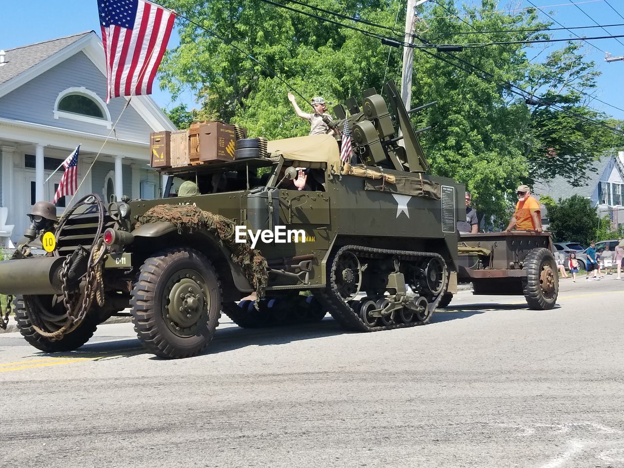 VEHICLES ON ROAD AGAINST BUILDINGS