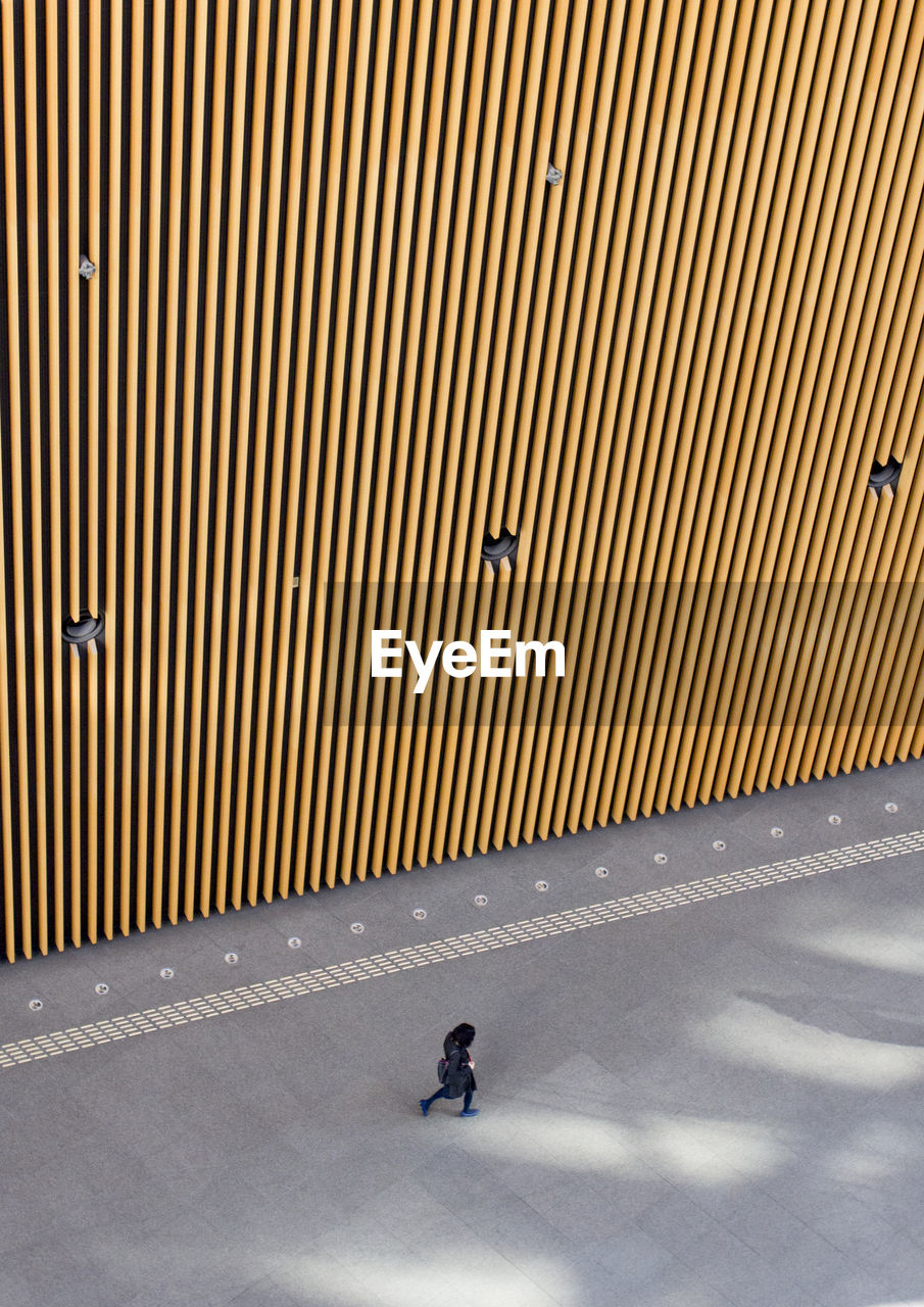 High angle view of woman walking on footpath