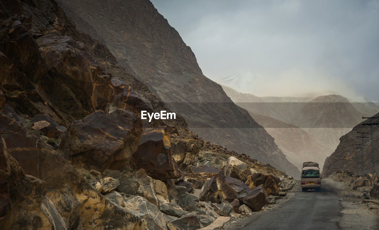 Road amidst mountains against sky