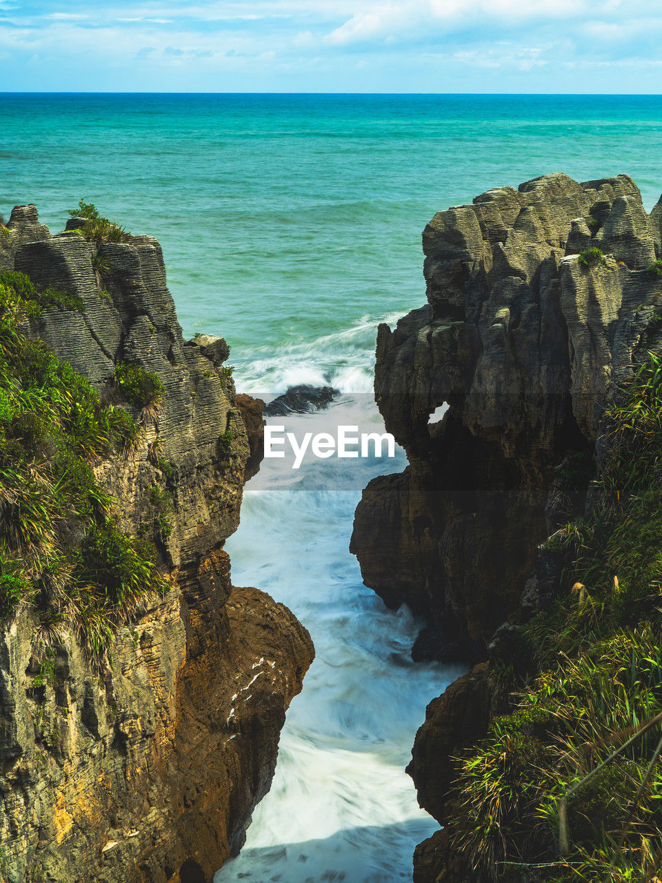 sea, water, land, rock, beauty in nature, beach, scenics - nature, sky, horizon over water, cliff, horizon, body of water, nature, coast, ocean, shore, bay, rock formation, tranquility, tranquil scene, terrain, no people, coastline, travel destinations, cove, cloud, travel, outdoors, idyllic, day, wave, motion, environment, non-urban scene, islet, vacation, seascape, blue, tourism, sports, tropical climate, landscape