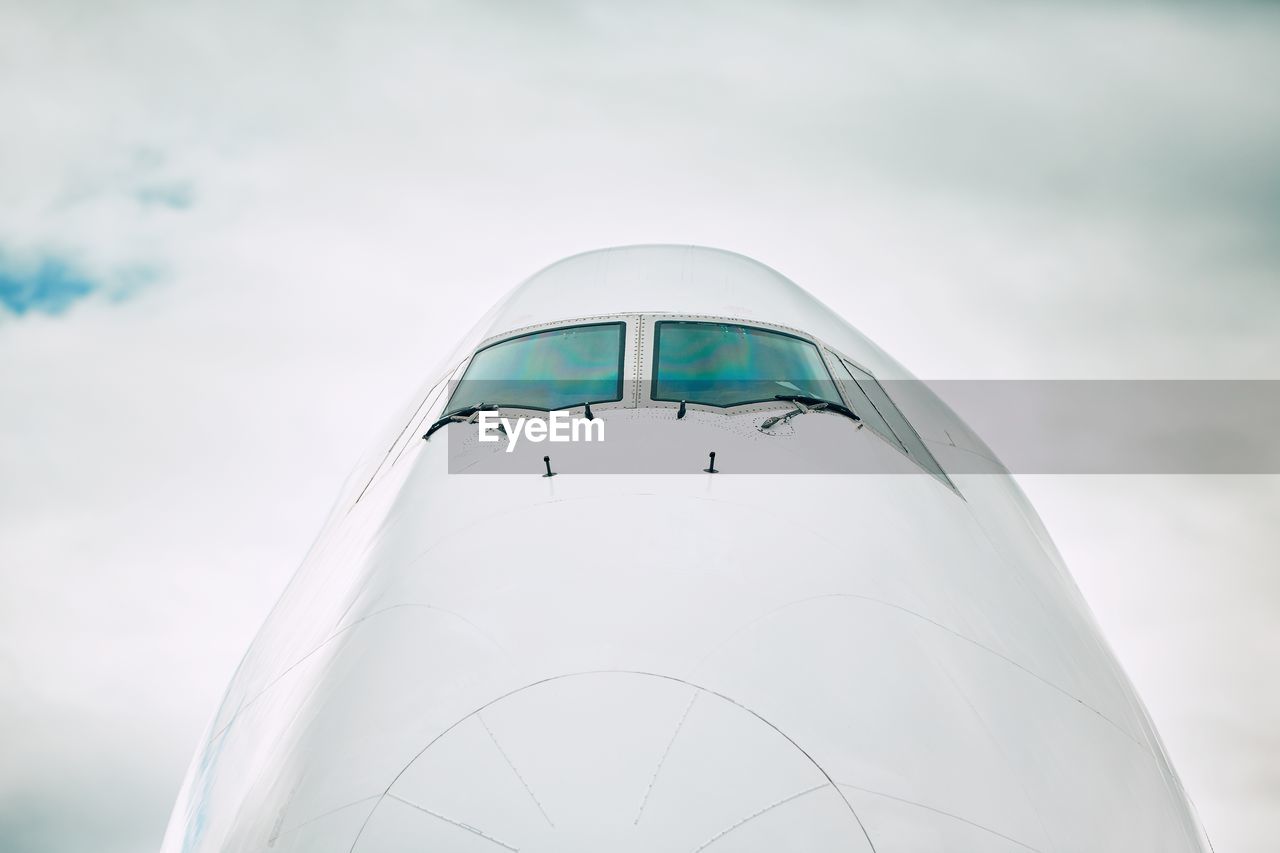 Close-up of airplane against sky