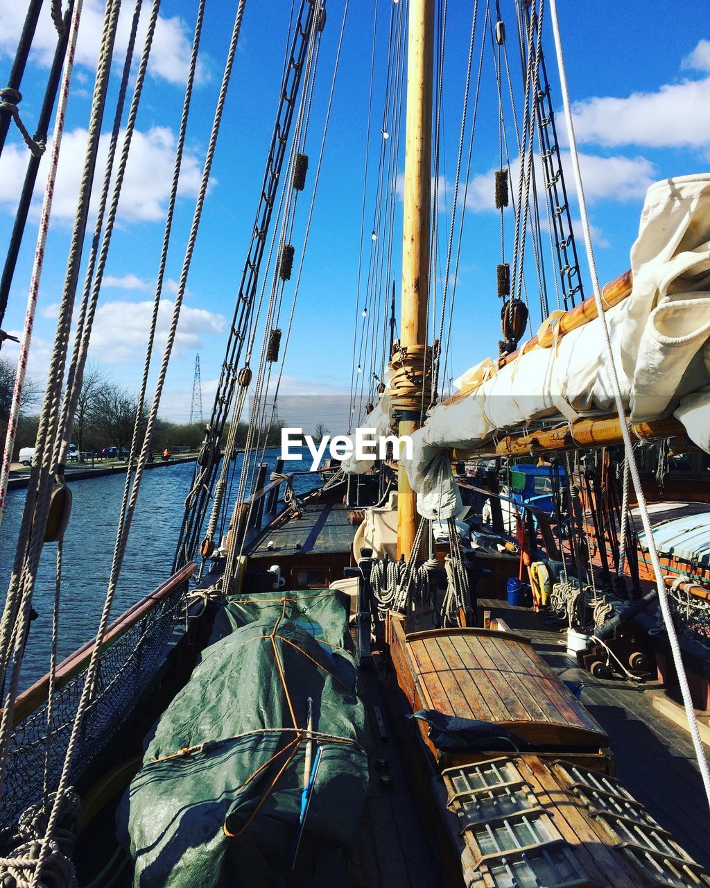 Boats moored at harbor against sky