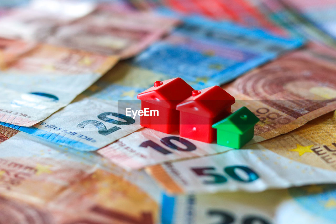 Table covered with euro banknotes with houses on top. real estate investment concept