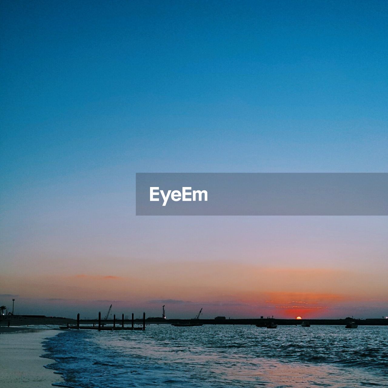 Scenic view of sea against clear sky at sunset