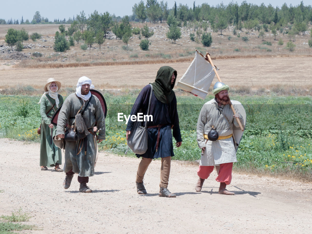 MEN STANDING ON FIELD