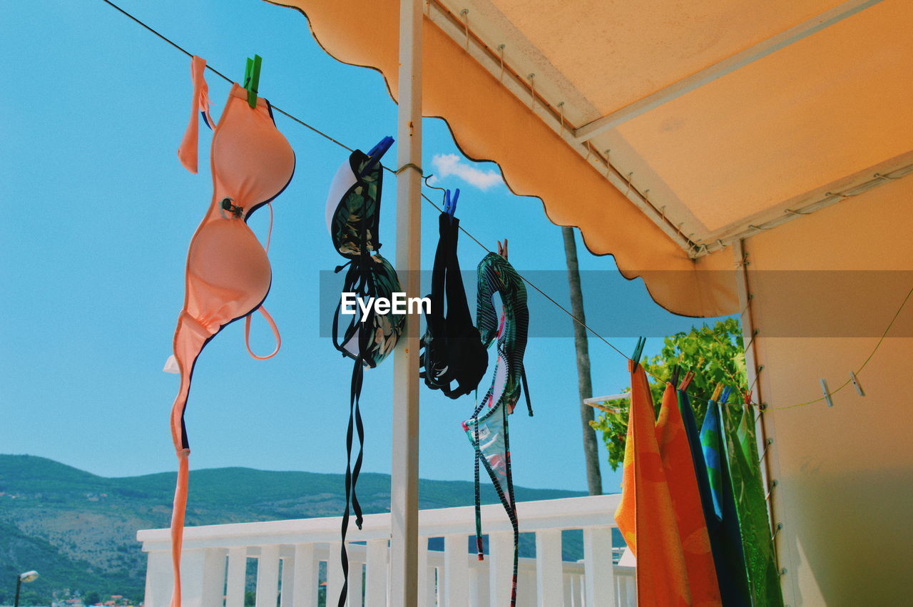 LOW ANGLE VIEW OF CLOTHES HANGING ON CLOTHESLINE