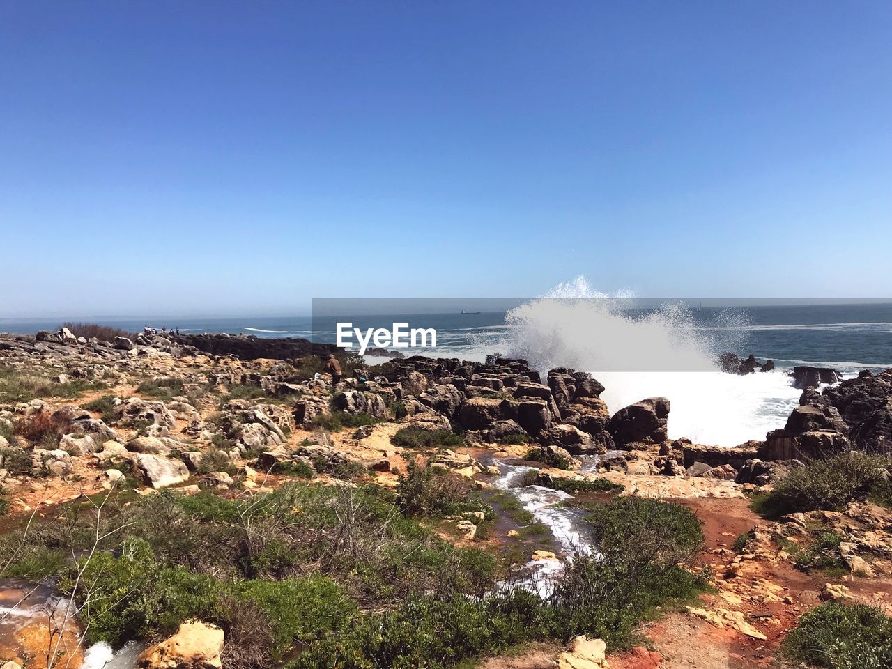 Scenic view of sea against clear blue sky