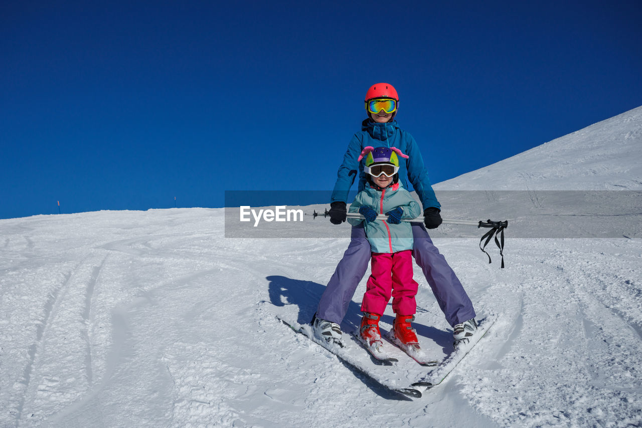 low angle view of man skiing on snow covered landscape