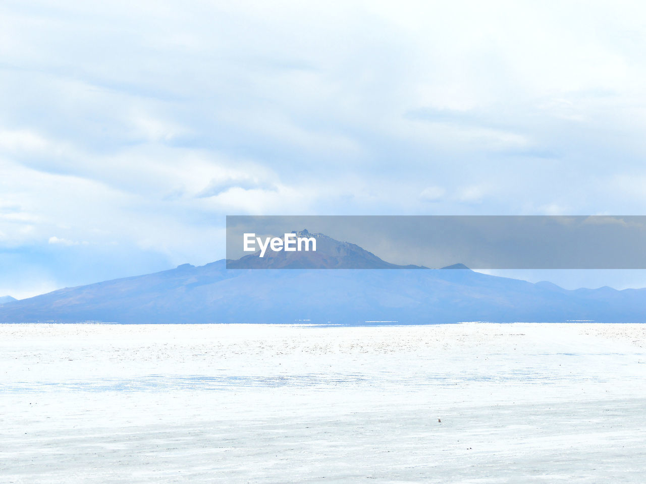 Scenic view of sea and mountains against sky