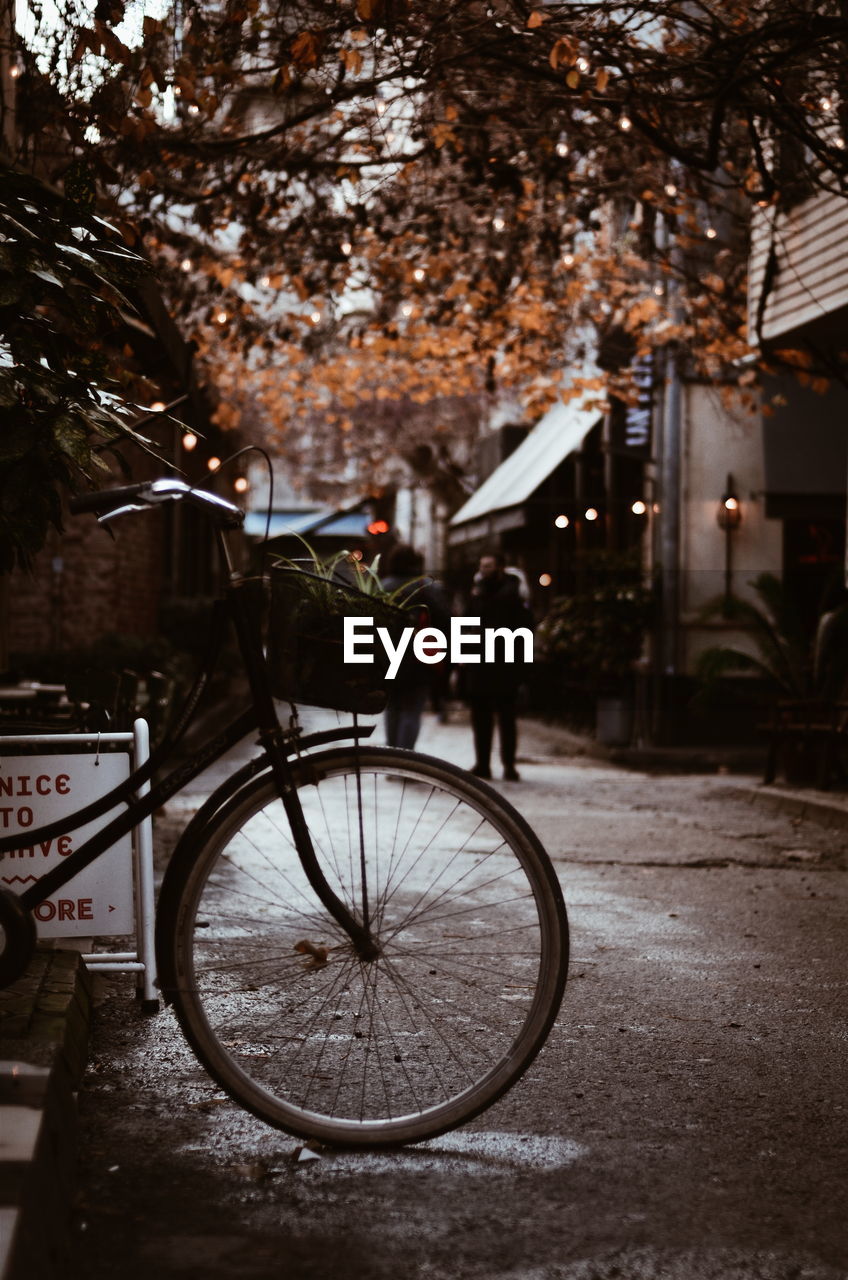 Man riding bicycle on street in rain