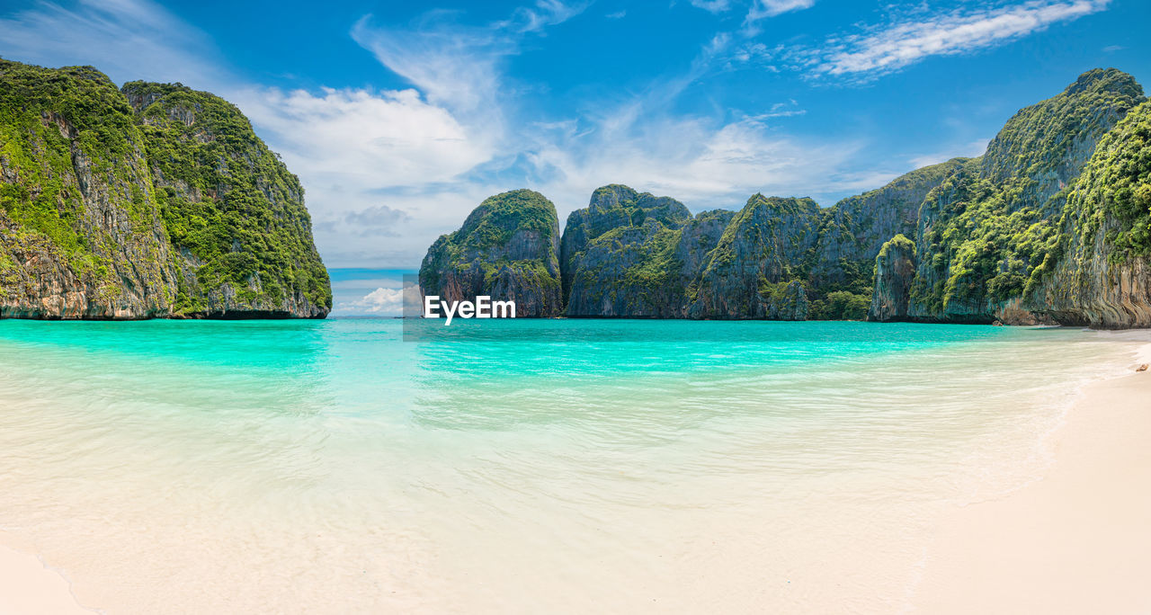 water, land, sea, scenics - nature, beach, beauty in nature, sky, nature, travel destinations, travel, tropical climate, trip, vacation, island, environment, holiday, landscape, tree, lagoon, tranquility, body of water, turquoise colored, tourism, sand, tranquil scene, idyllic, blue, summer, coast, bay, cloud, mountain, plant, coastline, outdoors, bay of water, no people, tropics, seascape, relaxation, rock, tourist resort, shore, day, ocean, sunlight, forest, non-urban scene, palm tree