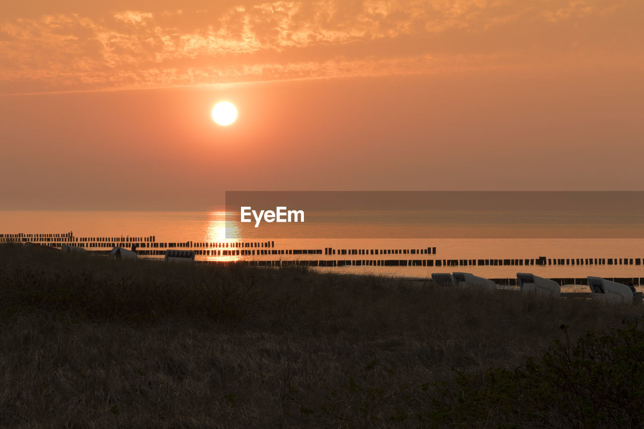 Scenic view of beach against sky during sunset