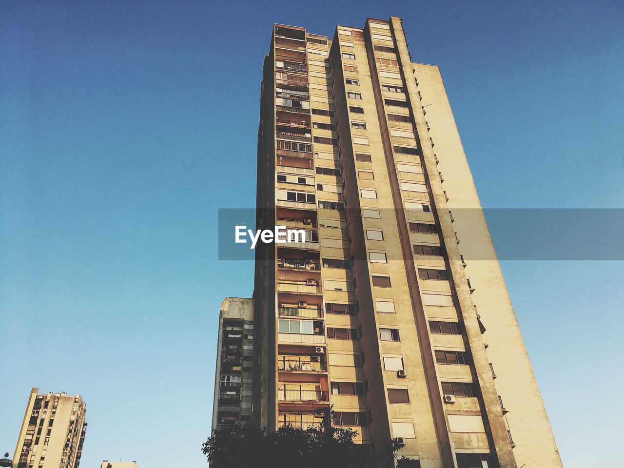 LOW ANGLE VIEW OF BUILDING AGAINST CLEAR BLUE SKY