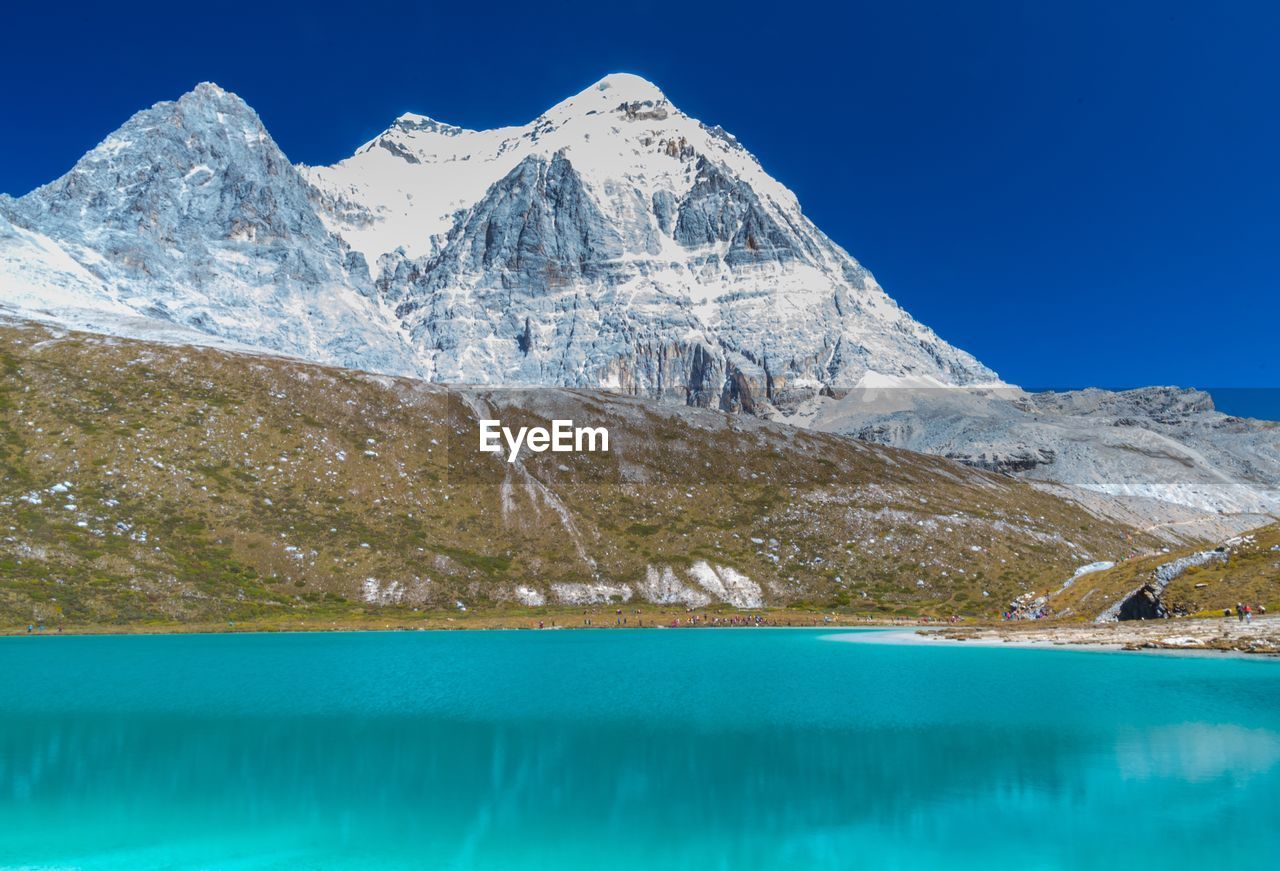 Scenic view of snowcapped mountains and lake