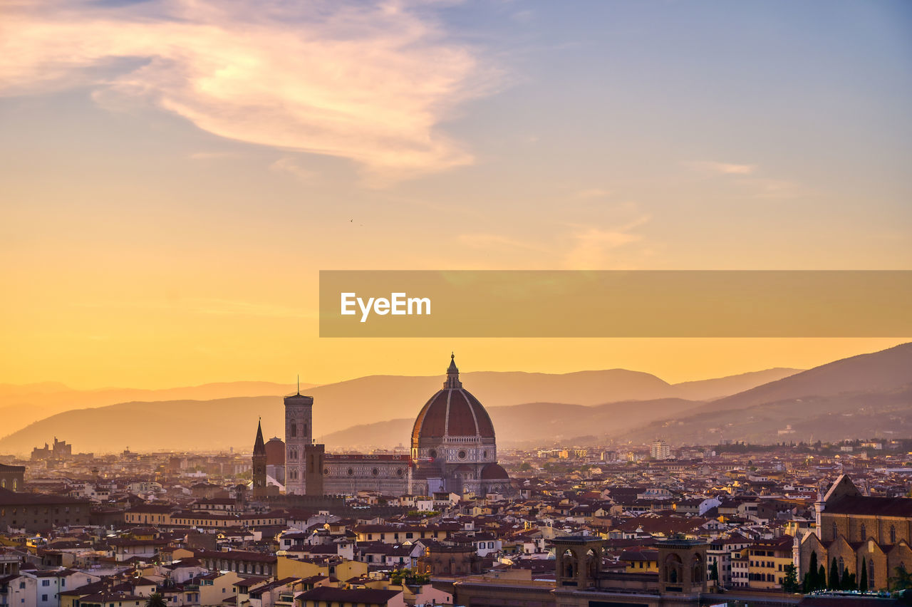 CITYSCAPE AGAINST SKY AT SUNSET