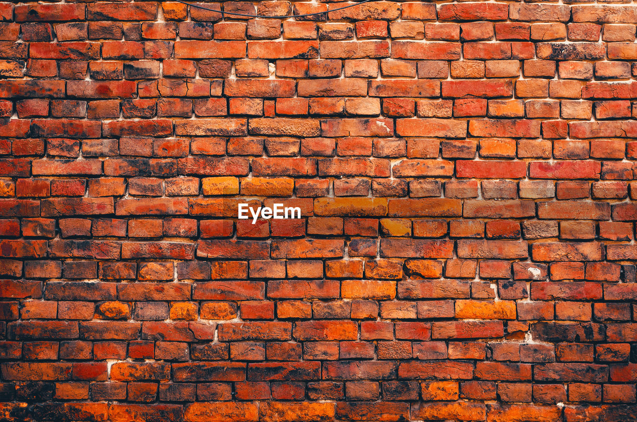 Vintage orange brick wall. brickwork with cracks. abstract background.