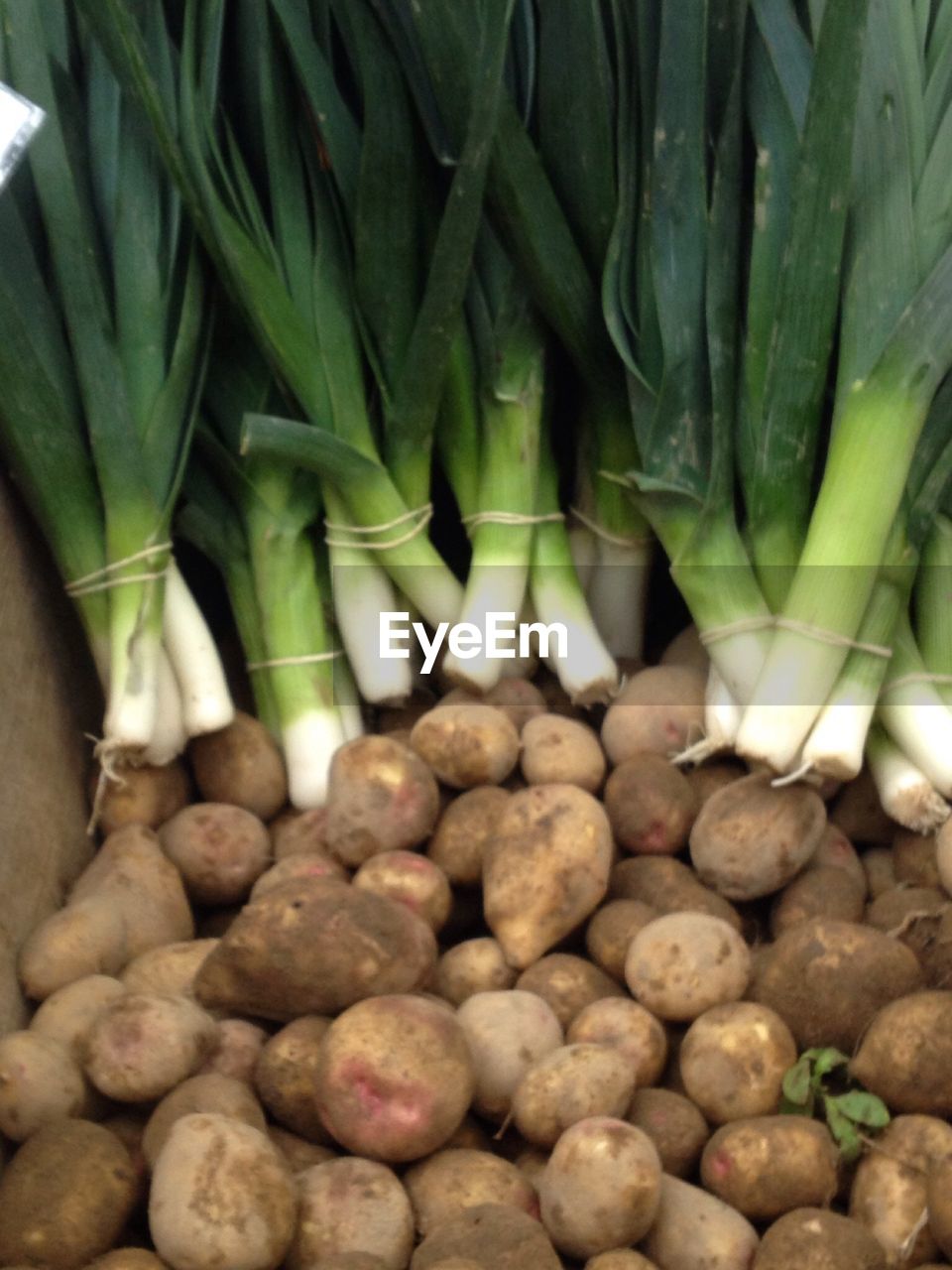 Potatoes and leeks for sale at market