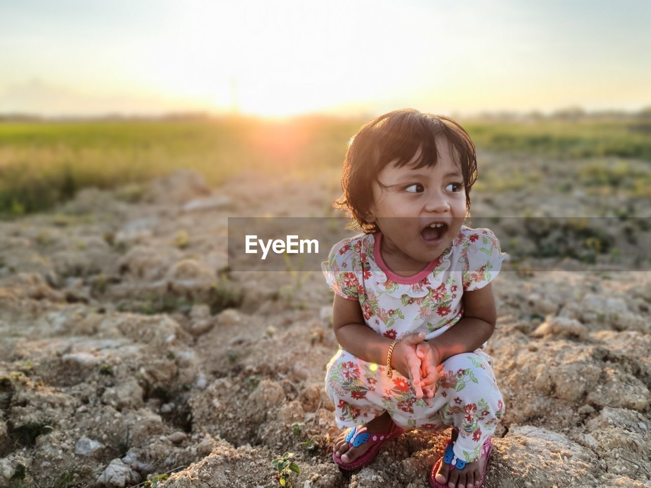 Portrait of cute girl sitting on land